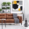Blanket On Brown Leather Settee In Living Room Interior With Pos