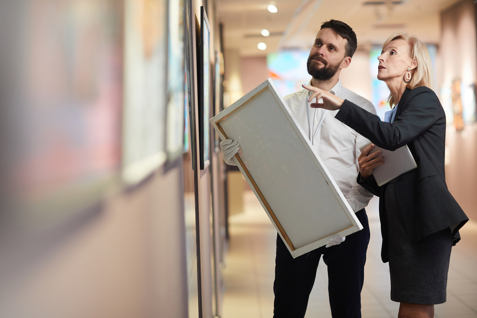 Portrait Of Elegant Mature Woman Buying Painting In Art Gallery
