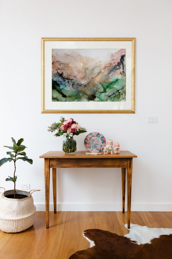 Blank Picture Frame Above A Side Table With Flowers And Pot Plant