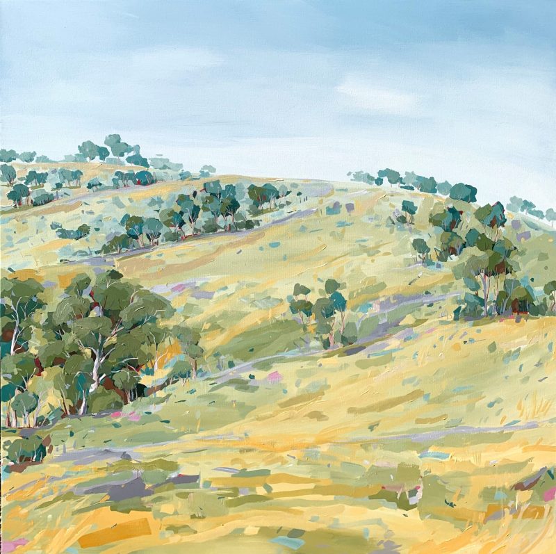 Sweeping Hills Under a Pale Blue Sky