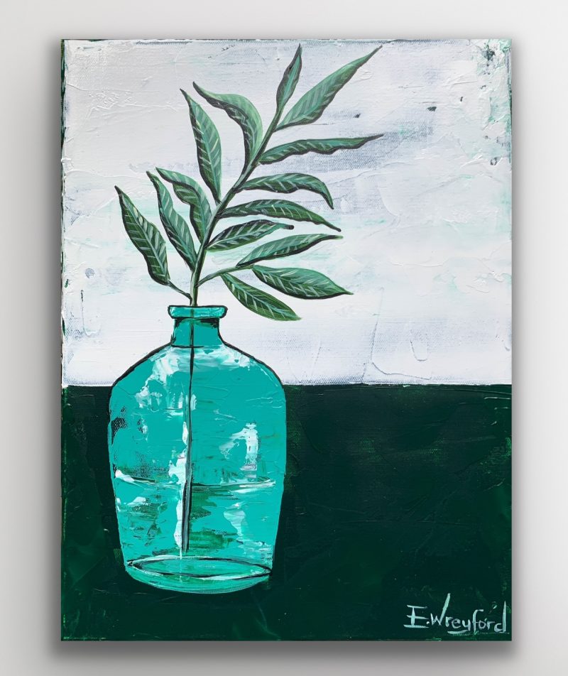Olive branch in an aqua blue glass vase