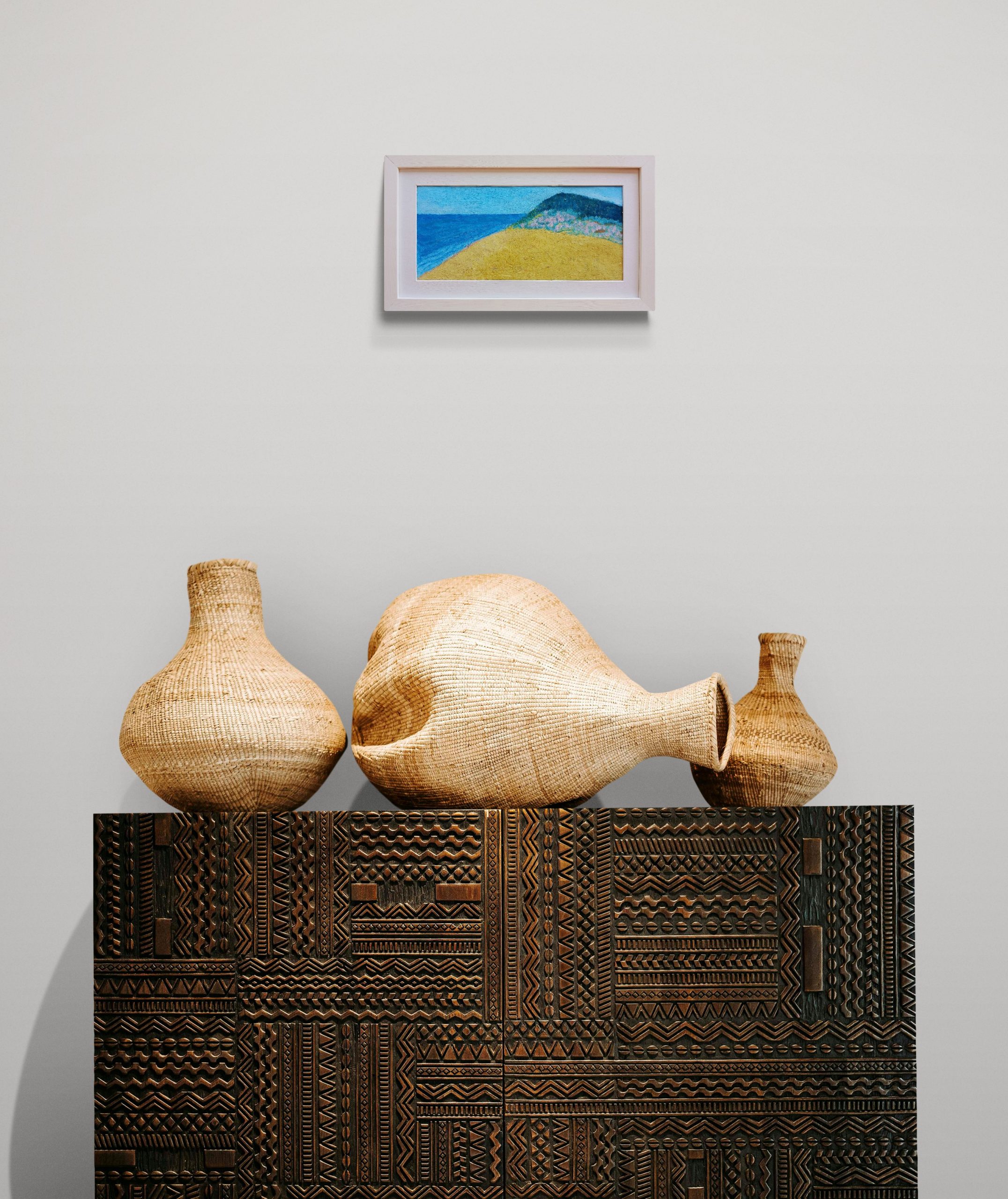 Woven Jugs Sitting On An African Cabinet