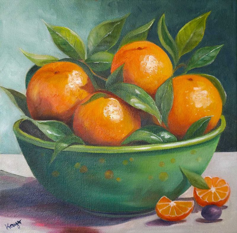 Oranges in a green bowl