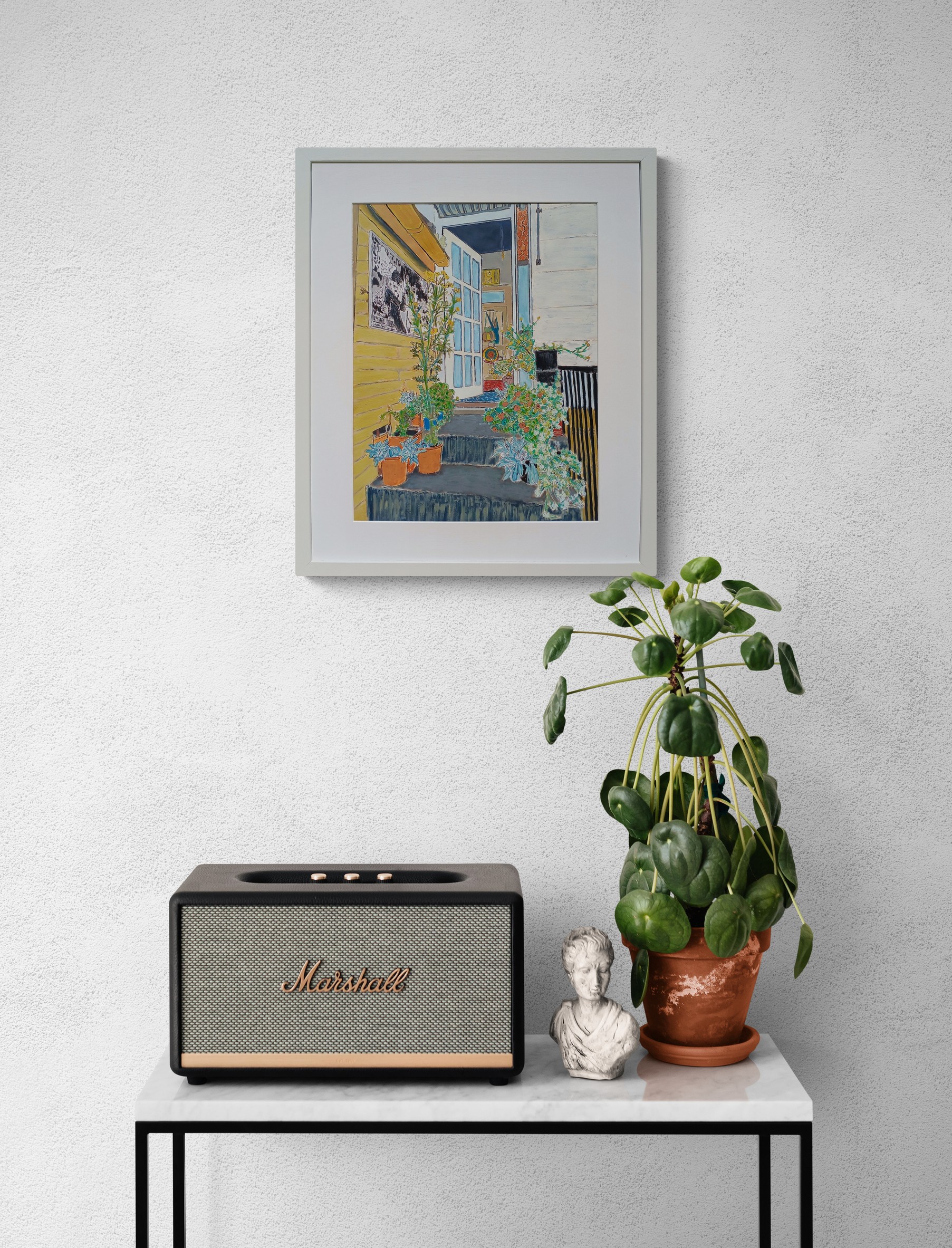 Console Table With A Speaker And Potted Plant